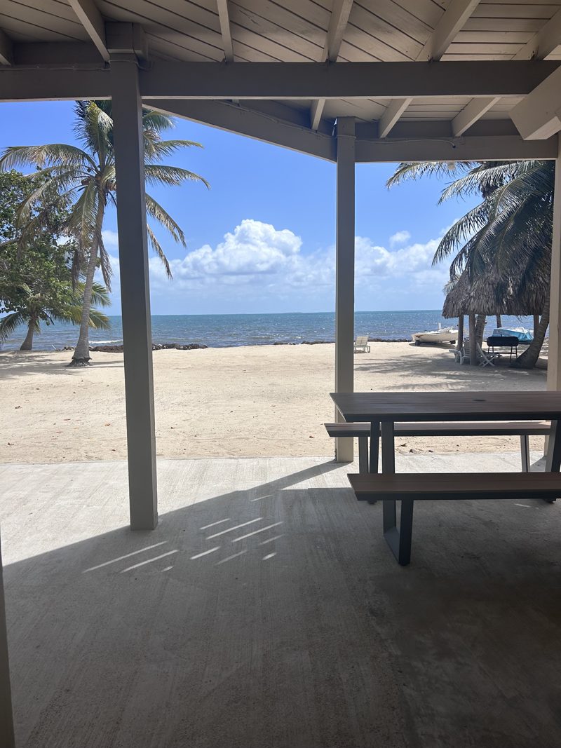 Palapa over white sand and the Caribbean