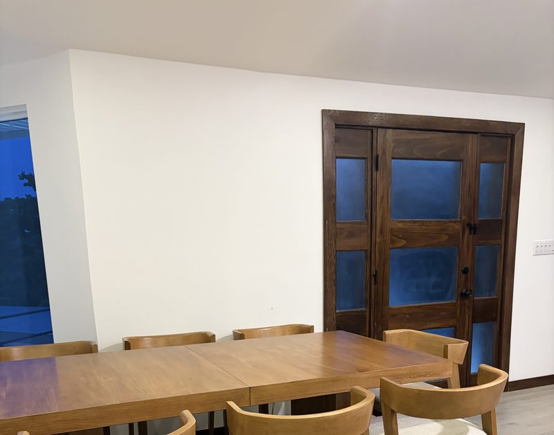 Dining table by wood and glass doors